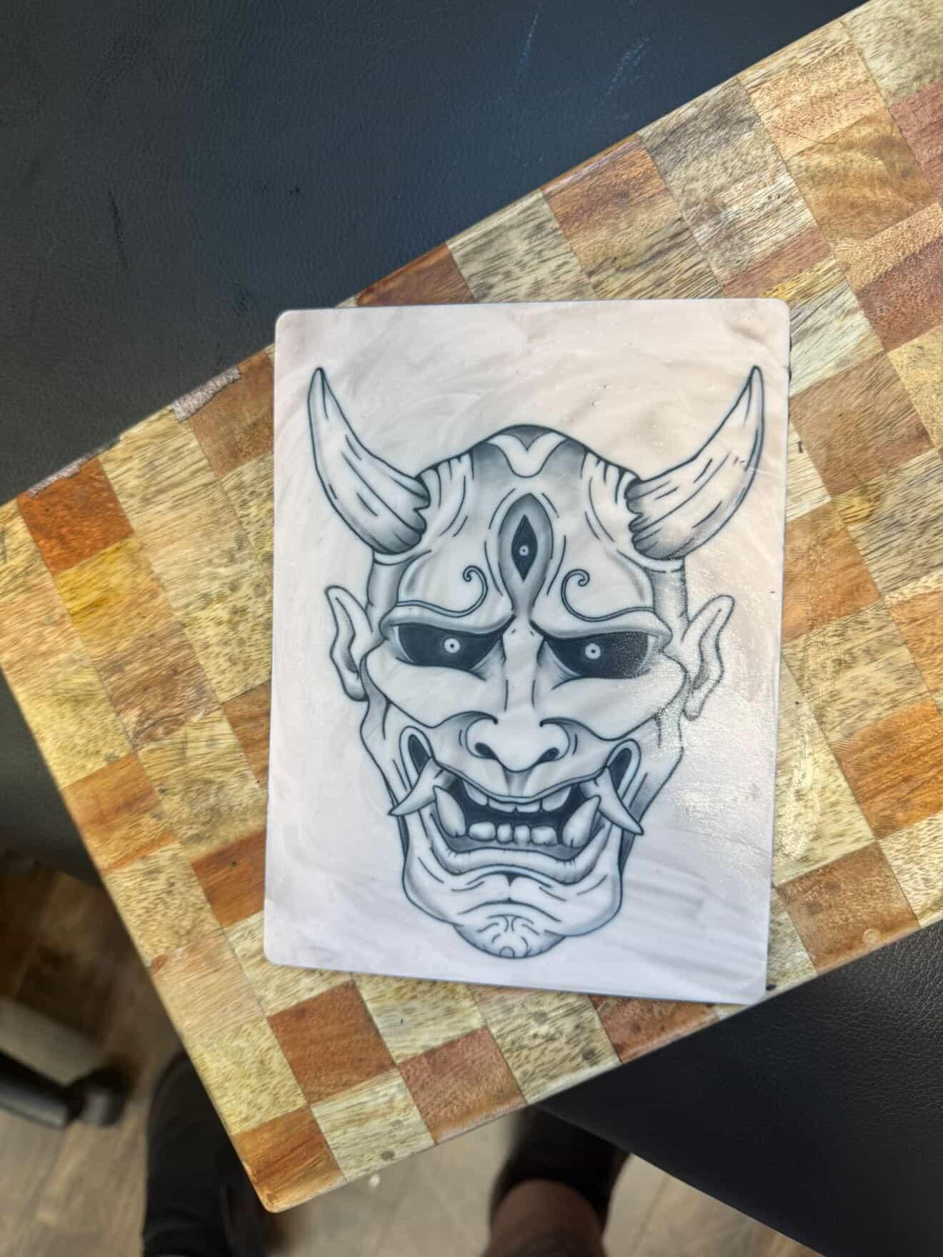 Finished Hannya mask artwork tattooed on practice skin